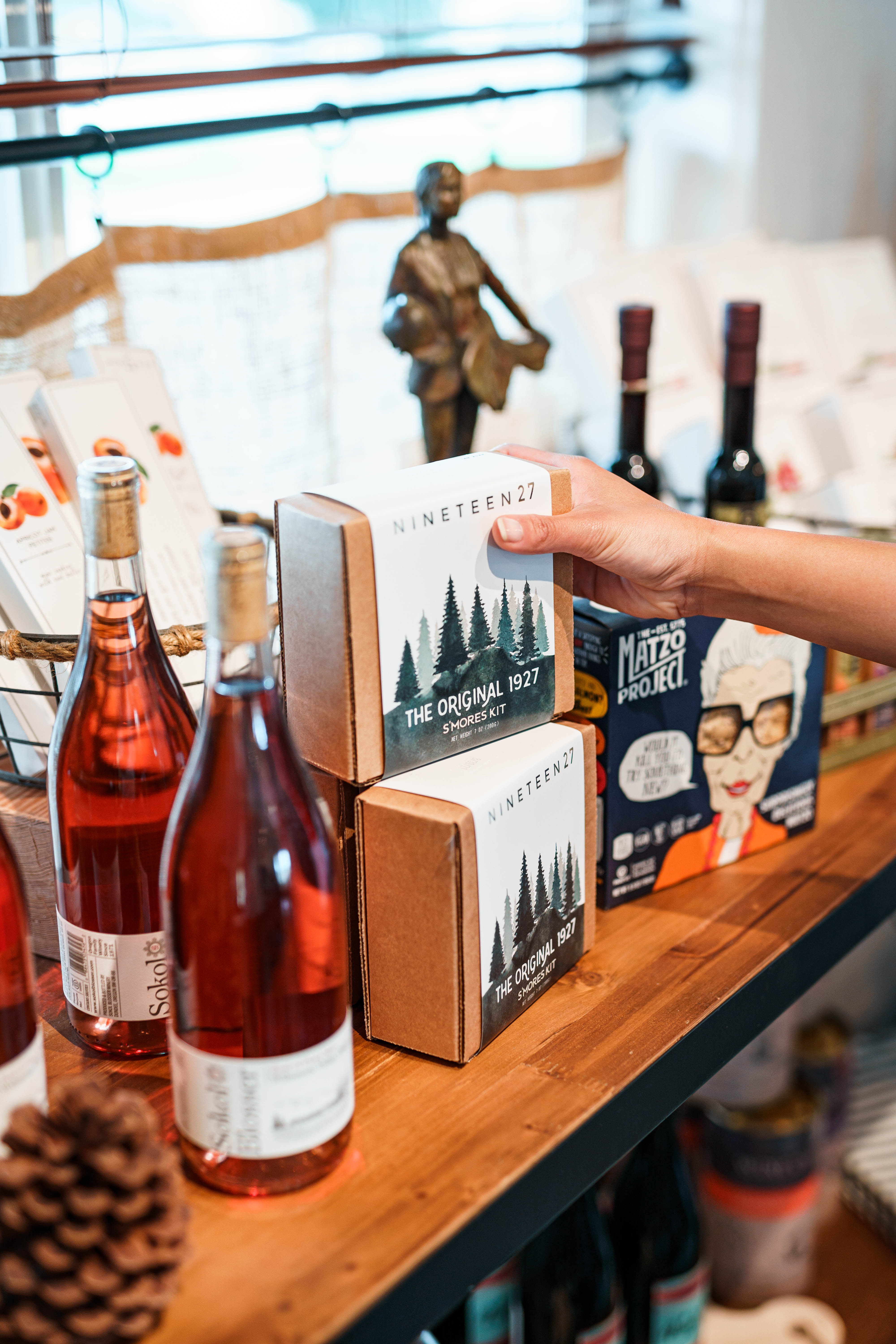 Image of The General Store at The Vintages Trailer Resort, featuring shelves filled with local wines, craft beers, artisanal snacks, and unique souvenirs, inviting guests to enhance their glamping experience.